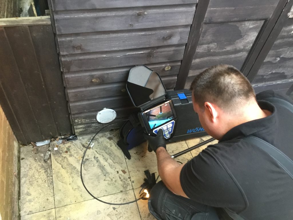 Daniel Hodgson master chimney sweep performing a chimney camera survey.